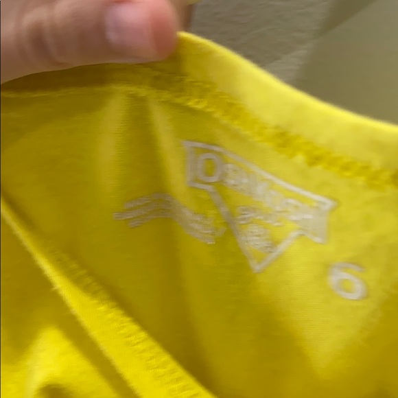 It is a yellow shirt with a flower on it - Picture 4 of 4